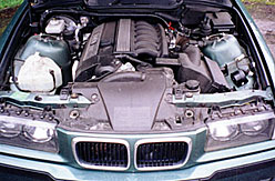 Image of a BMW 328 Coupe with the bonnet open exposing the engine 