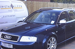 Image of clean blue Audi next to car valeting van